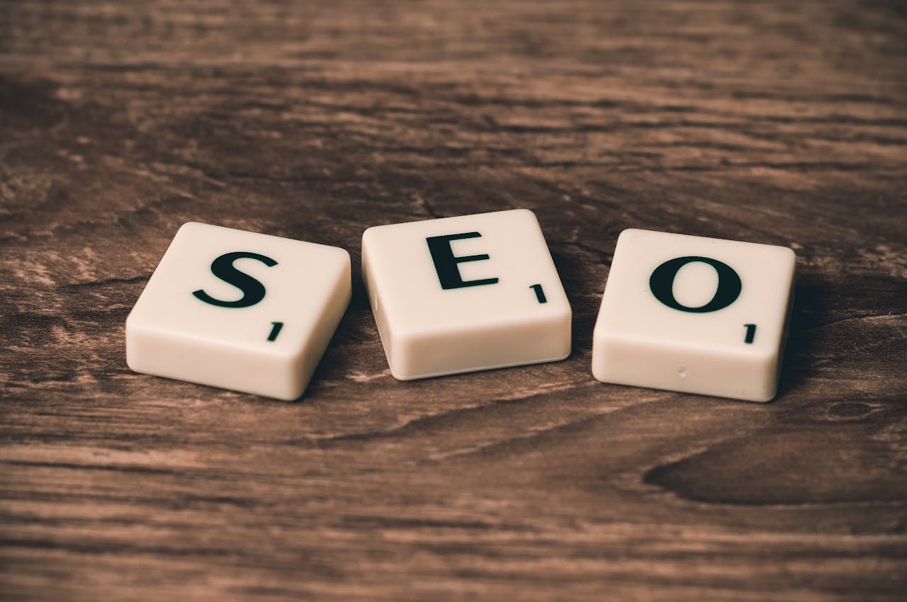 service-06 Scrabble tiles spelling SEO on a wooden surface. Ideal for digital marketing themes.
