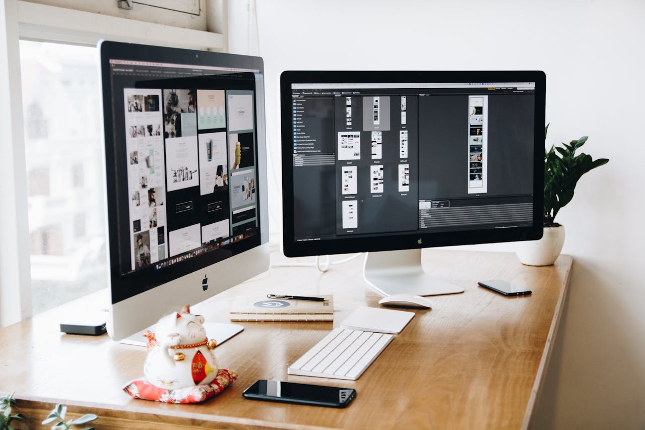 our-stories A well-organized design workspace with dual monitors and design software on display.